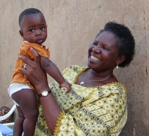 Fatou Batta holding baby in Burkina Faso village.